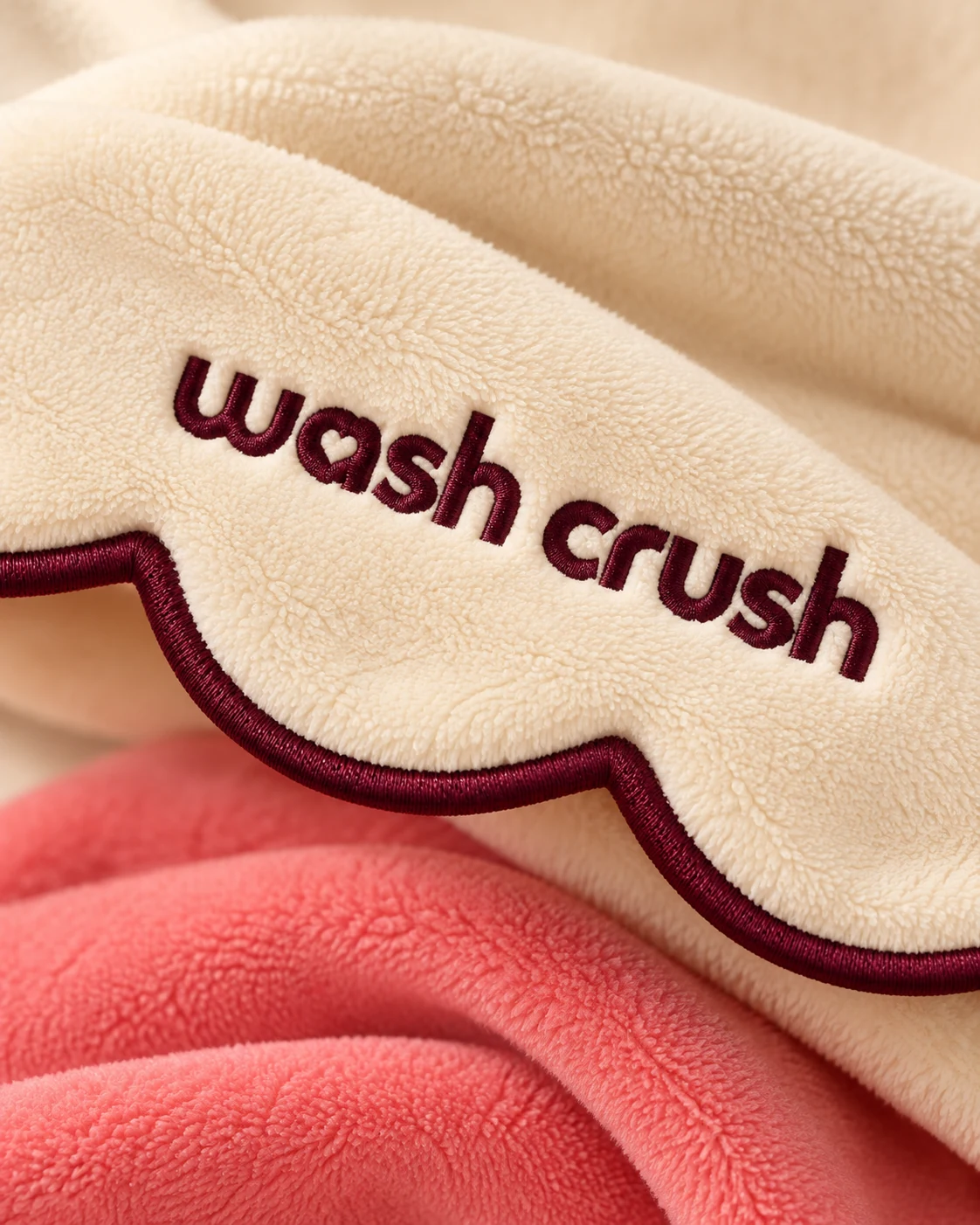 Close-up of the heart inside the embroidered Wash Crush logo, fine microfiber and scalloped Black Cherry trim